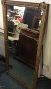 A large gilt framed mirror.