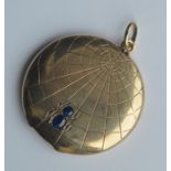 An unusual circular gold locket in the form of a s