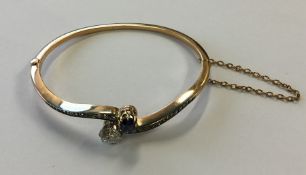 A good sapphire and diamond bangle in claw mount a