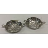 A pair of circular silver bonbon dishes decorated