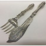 A pair of pierced silver fish servers decorated wi