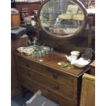 An oak four drawer dressing chest.