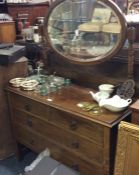 An oak four drawer dressing chest.