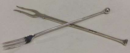 A stylish seal top silver pickle fork together wit
