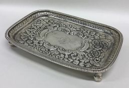 An Irish silver embossed teapot stand with floral