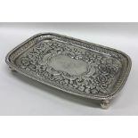 An Irish silver embossed teapot stand with floral