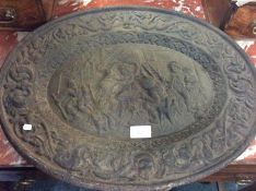 A cast iron oval plaque.