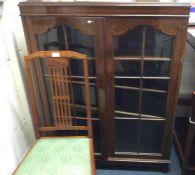 An oak glazed two door cupboard.