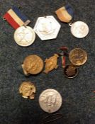 A collection of old commemorative badges and medal