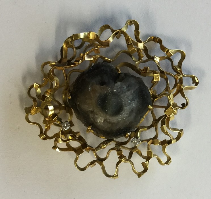 An 18 carat modernistic brooch inset with diamonds