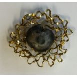 An 18 carat modernistic brooch inset with diamonds