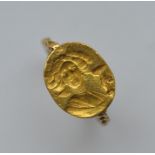 A heavy gold early signet ring. Approx. 7.1 grams.