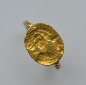 A heavy gold early signet ring. Approx. 7.1 grams.