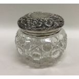 A silver embossed top dressing table jar. Est. £15