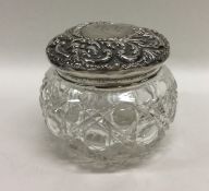 A silver embossed top dressing table jar. Est. £15