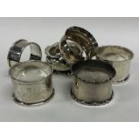 A collection of silver and other napkin rings. App