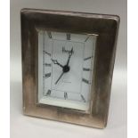 A modern silver mounted Harrods mantle clock. Est.