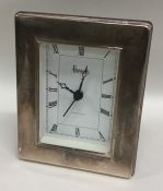 A modern silver mounted Harrods mantle clock. Est.