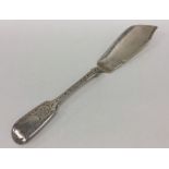 An engraved silver butter knife decorated with flo