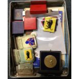 A tin containing medallions and medals.