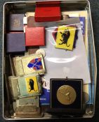 A tin containing medallions and medals.