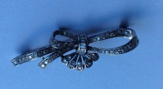 A platinum French diamond brooch in the form of a