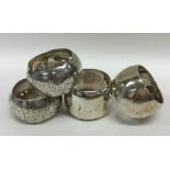 A group of four heavy silver napkin rings engraved