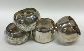 A group of four heavy silver napkin rings engraved