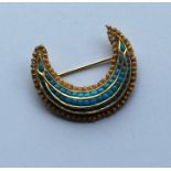 A high carat gold Eastern turquoise crescent brooc