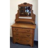 A satinwood three drawer dressing chest. Est. £25