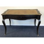 A Continental ebony and brass inlaid desk with lea