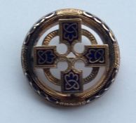 A circular gold and enamelled target brooch engrav