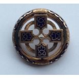 A circular gold and enamelled target brooch engrav