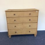 A massive pine four drawer chest on turned support