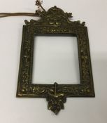 A heavy brass wall mount with embossed decoration.