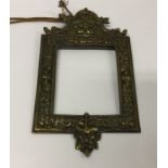 A heavy brass wall mount with embossed decoration.