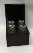 A boxed burr walnut four bottle decanter set with