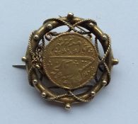 A gold Islamic coin mounted as a brooch. Approx. 8