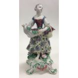 A decorative Bow figure of a lady in floral dress