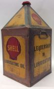 A large "Shell Leadership Lubrication" oil can in