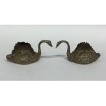 A pair of silver figures of swans with textured bo