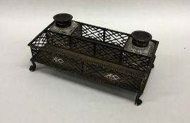 A Georgian two bottle silver inkstand with pierced