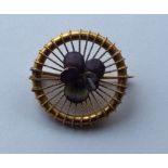 An attractive 15 carat gold circular brooch enamel