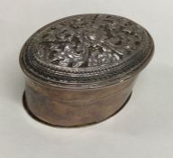 An Indian oval silver box with embossed decoration