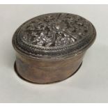 An Indian oval silver box with embossed decoration