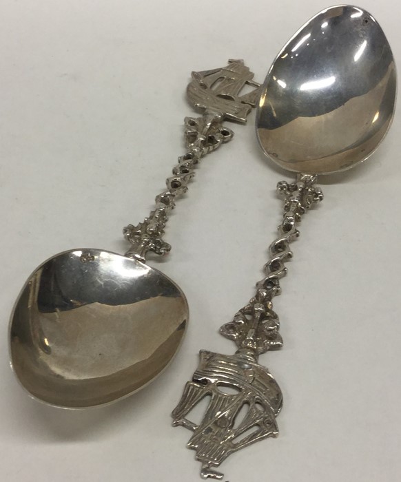 A pair of silver spoons attractively decorated wit