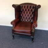 A leather button back smoker's chair on cabriole l