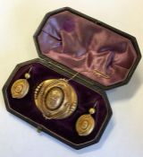 A boxed gold Victorian dome brooch together with m
