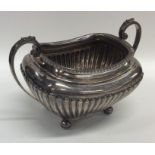 A silver half fluted sugar bowl on reeded supports