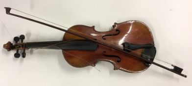An old cased violin and bow. By Apollo. Est. £20 -